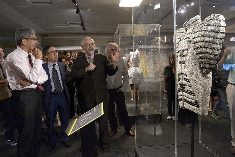 Viewing a dress made by Turkish fashion label Dice Kayek at the Jameel Prize 3 exhibition yesterday are (from left) Minister for Communications and Information Yaacob Ibrahim; NTU College of Humanities, Arts, and Social Sciences dean Alan Chan; and M