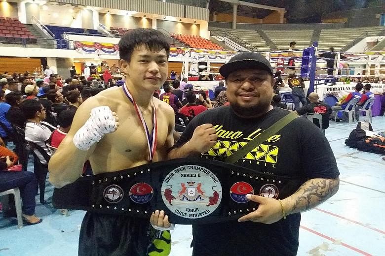 Terrence Teo and his coach Arvind Lalwani after winning his first professional muay thai championship. He says his good technique makes up for a lack of experience.