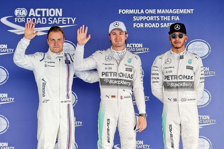 Mercedes F1 driver Nico Rosberg (centre) and third-fastest qualifier Valtteri Bottas (left) of Williams looking delighted while world champion Lewis Hamilton is subdued after being beaten to pole position in Sochi.