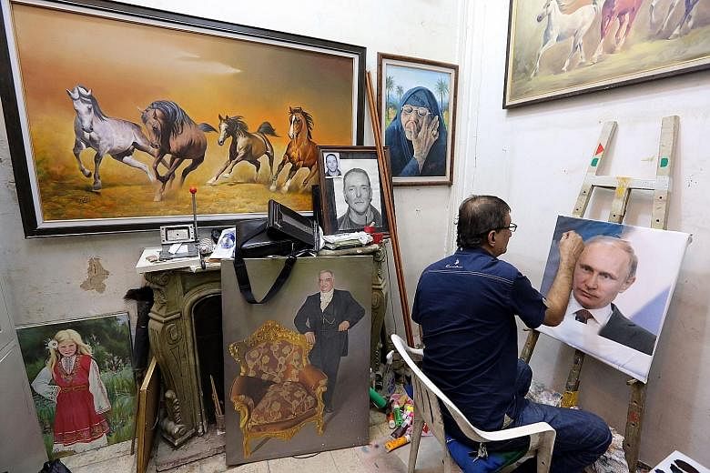 Iraqi artist Mohammed Karim Nihaya painting a portrait of Russian President Vladimir Putin, whose popularity in Iraq has been on the rise since Russia joined the fray in Syria.