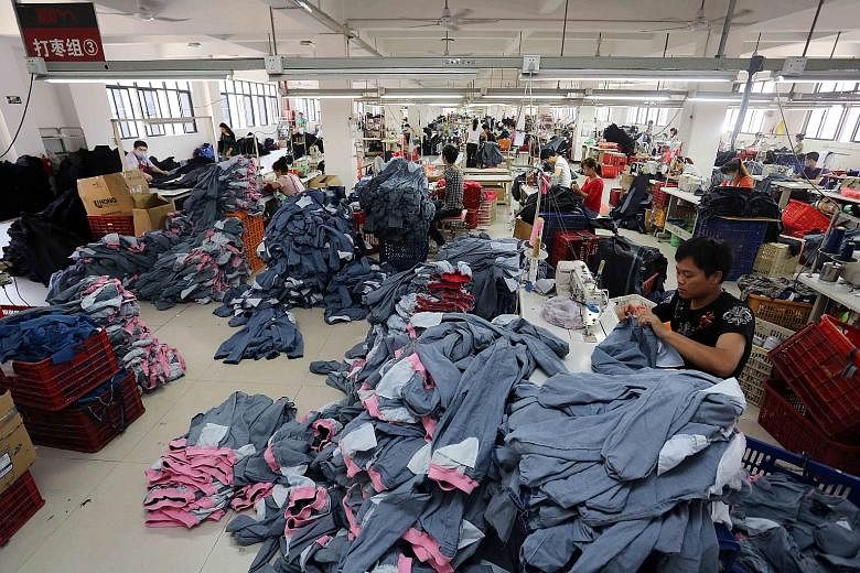 Chinese workers making jeans at a clothing factory in Shishi, east China's Fujian province. China's exports, imports and trade balance data for September, to be released tomorrow, will likely give investors clues on the strength of the Chinese econom