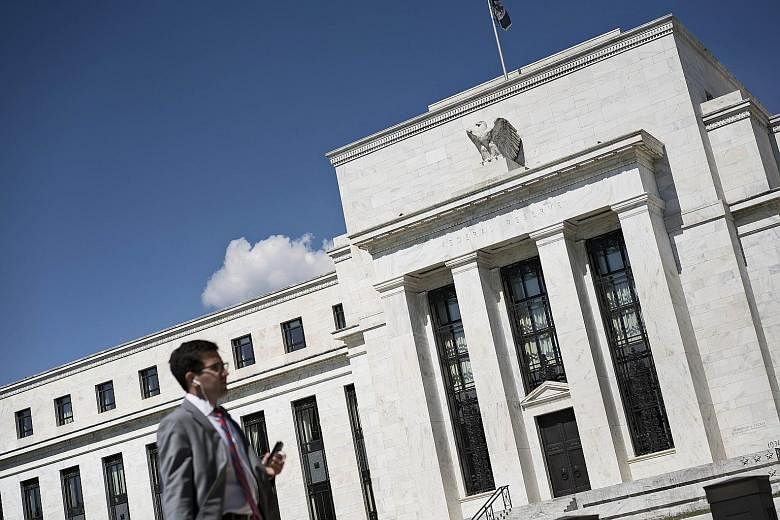 Among the factors that weigh down corporate earnings is uncertainty over an interest rate hike by the US Federal Reserve (left), analysts say.