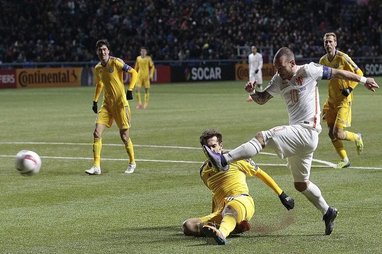 Wesley Sneijder (in white) of the Netherlands scoring his side's second goal in the 2-1 victory against Kazakhstan in the Euro 2016 Group A qualifier in Astana, Kazakhstan on Saturday. In order to qualify, the Dutch must beat the Czech Republic tomor