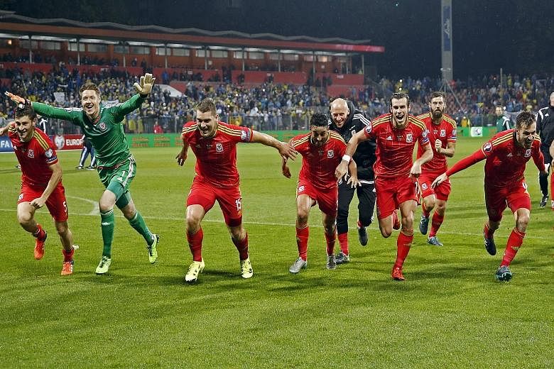 Wales captain and Real Madrid star Gareth Bale (third from right) and team-mates celebrating after they qualified for Euro 2016 - their first major Finals since the 1958 World Cup.