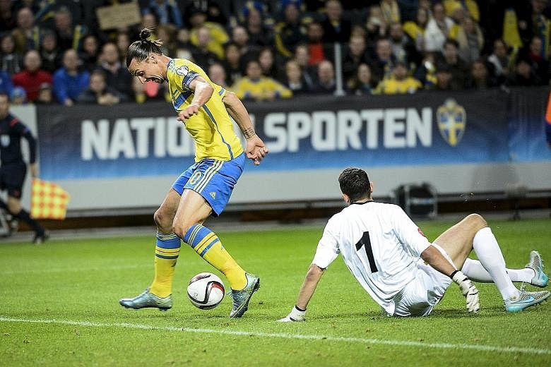Sweden's Zlatan Ibrahimovic dribbling the ball past Moldova 'keeper Ilie Cebanu to score the opening goal. Despite the 2-0 victory, Russia's storming finish means the Swedes must win a play-off to avoid missing a second straight major tournament.