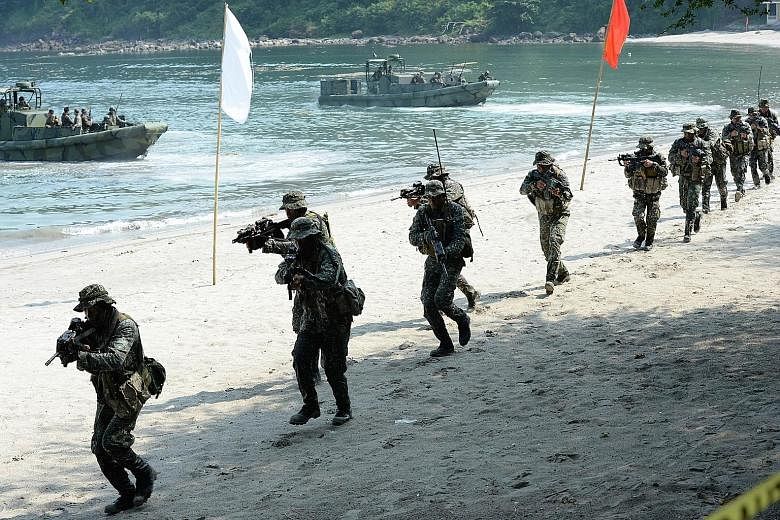 Philippine Marines simulating a beach landing as part of their annual joint naval exercises with the US in Cavite province, west of Manila, last week. The US says it is planning "freedom of navigation" patrols near artificial islands built by China i