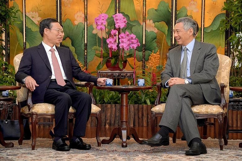 Chinese Vice-Premier Zhang Gaoli calling on PM Lee Hsien Loong at the Istana, where they reaffirmed close bilateral ties. Mr Lee said he is looking forward to Chinese President Xi Jinping's state visit next month.