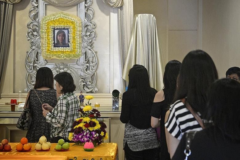 Colleagues of the late Lim Siaw Chian, who died in the fire that broke out at Leeden National Oxygen on Monday, paying their respects at her wake in Skudai, Johor, yesterday.