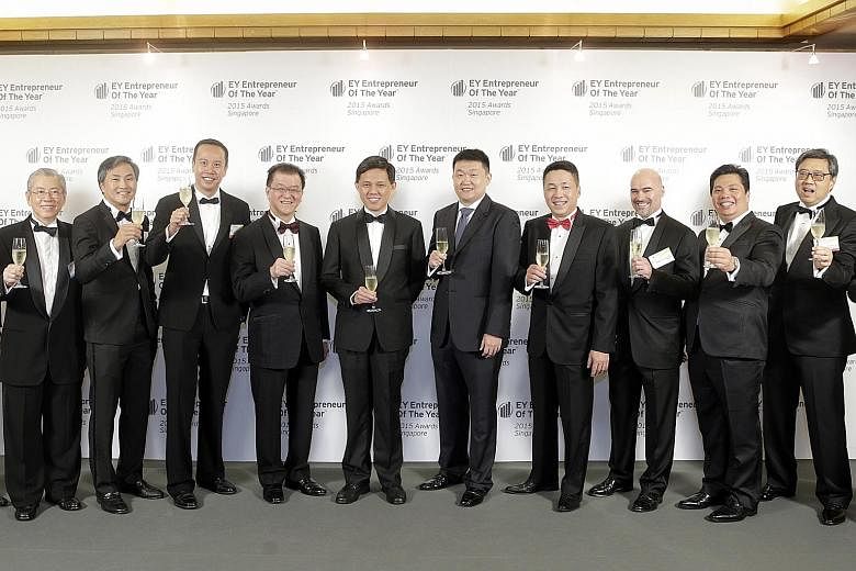 Celebrating at the awards ceremony yesterday were (from left) Mr Wong Ngit Liong, chairman and CEO of Venture Corp and chairman of EOY Singapore Academy; Dr Michael Tan, group CEO and co-founder of Fullerton Healthcare Group; Mr Mark Lee, CEO of Sing