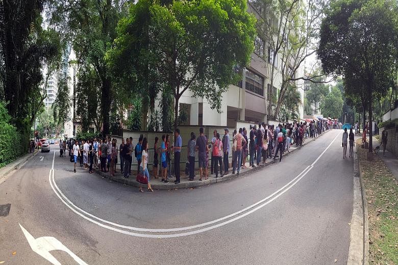 Hundreds of Myanmar nationals queueing outside the Myanmar Embassy yesterday to cast their votes for the country's general election on Nov 8. Many queued from as early as 5am outside the embassy in St Martin's Drive off Tanglin Road, according to vol