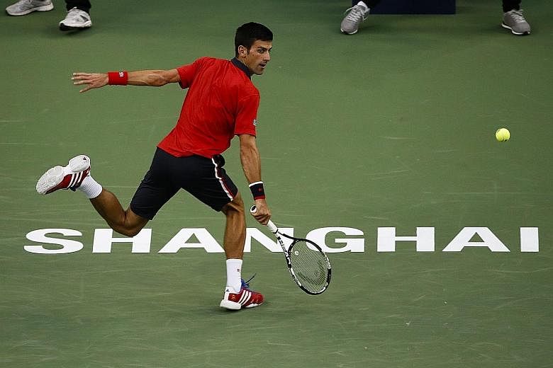 Novak Djokovic playing a running backhand against Feliciano Lopez at the Shanghai Masters yesterday. The world No. 1 stayed on track for a ninth title of the year.