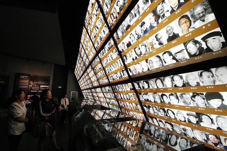 Visitors looking at photos of Nanjing Massacre survivors at the Nanjing Massacre Memorial Hall in Nanjing last week. Unesco has added materials documenting the event to its Memory of the World Register.