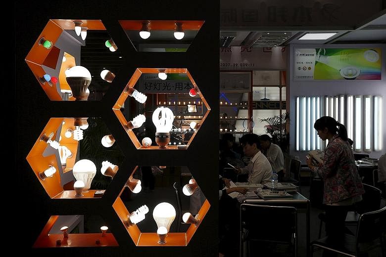 Light bulbs on display at a booth during the Canton Fair in Guangzhou on Thursday. The fair gathers tens of thousands of Chinese exporters and foreign buyers in one place and has been regarded as an indicator of how well the Chinese economy is doing.