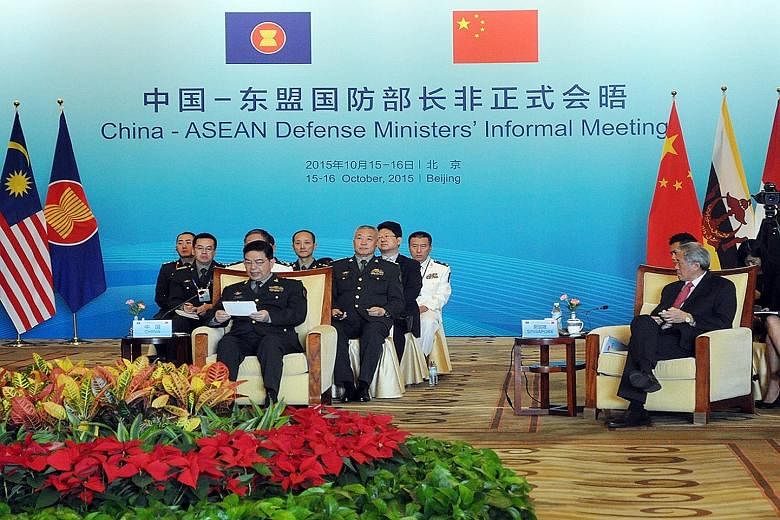 Dr Ng Eng Hen (right) and China's Defence Minister Chang Wanquan (left, front row) at the inaugural China-Asean defence ministers' informal meeting in Beijing yesterday. Dr Ng emphasised the need for Asean and China to keep working together to mainta