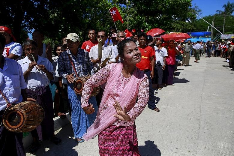 Myanmar's ethnic Rakhine people dancing to welcome opposition leader Aung San Suu Kyi during her campaign rally for the upcoming general election in Thandwe yesterday. Ms Suu Kyi has opted to skip state capital Sittwe and other more restive areas of 