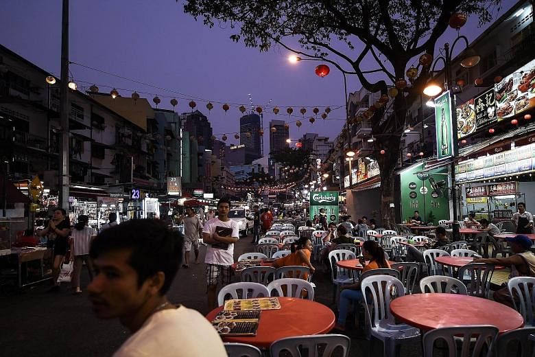 Jalan Alor, a popular food street in Kuala Lumpur. Issues such as cost of living, unemployment, and the impact of the goods and services tax, levied in April, topped Malaysians' list of grouses in Merdeka Centre's latest poll.