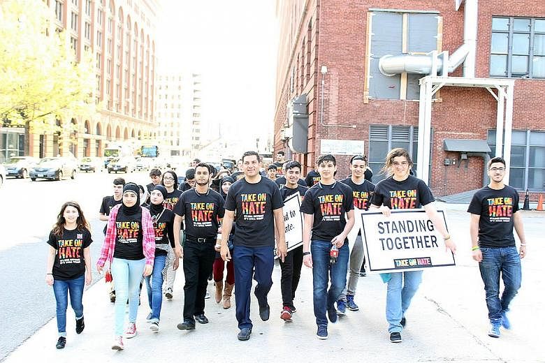 Marwa Khalil (in pink), 15, with other youth activists who are part of the Take On Hate campaign against discrimination. Marwa was participating in a peaceful rally in support of building a mosque in Sterling Heights, Michigan, when a woman charged a