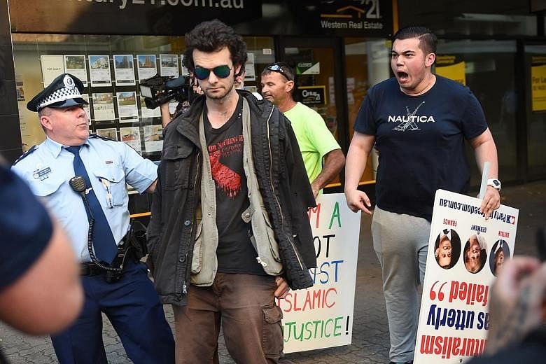 An anti-Muslim protester (right) shouting at a Muslim supporter during a demonstration outside the Parramatta Mosque in Sydney on Oct 9.