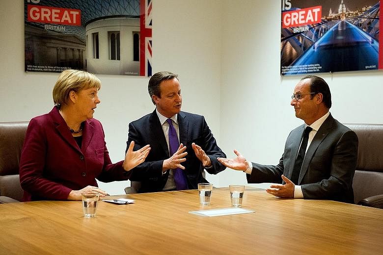 Mr David Cameron (centre) with German Chancellor Angela Merkel and French President Francois Hollande at the European Union summit in Belgium on Thursday.