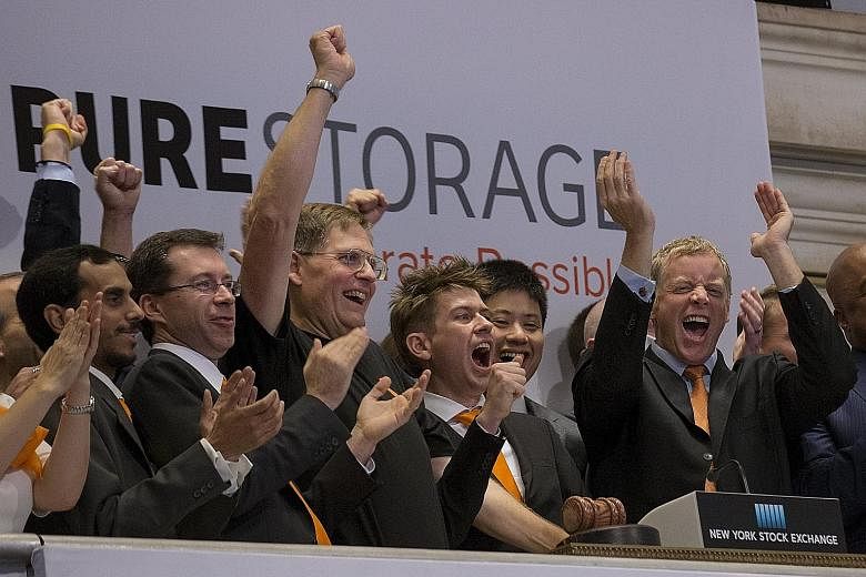 Pure Storage chief executive Scott Dietzen (at far right) and company officials celebrating its IPO at the New York Stock Exchange on Oct 7. Affected by the weaker venture investing climate this year, the offering took its market cap to a level that 