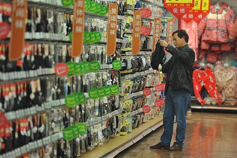 A customer browsing in a supermarket in Fuyang, China's Anhui province. China is at the centre of the stock market drama, where the slowing economy has continued to unnerve investors.