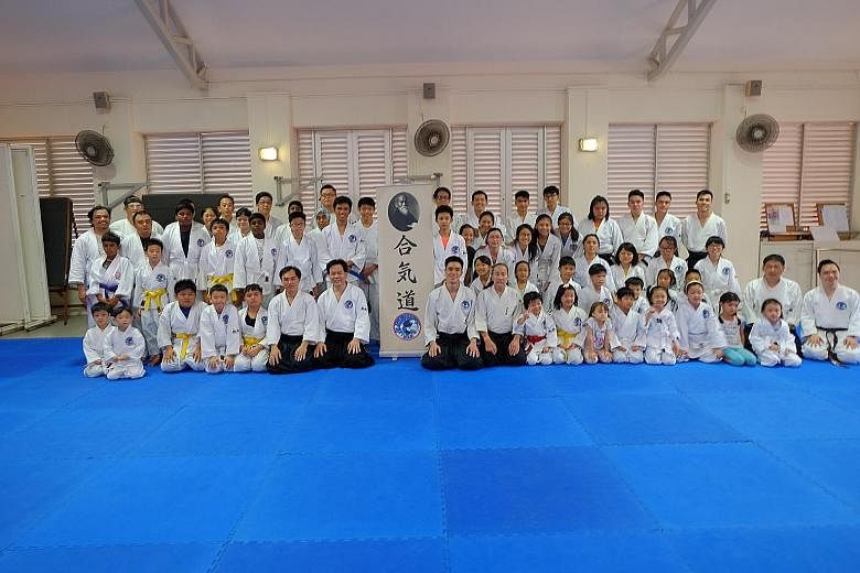 Mr Patrick Chan (front row, seventh from left) and his martial arts students at the first anniversary of Aikido Tai Shin Kai.