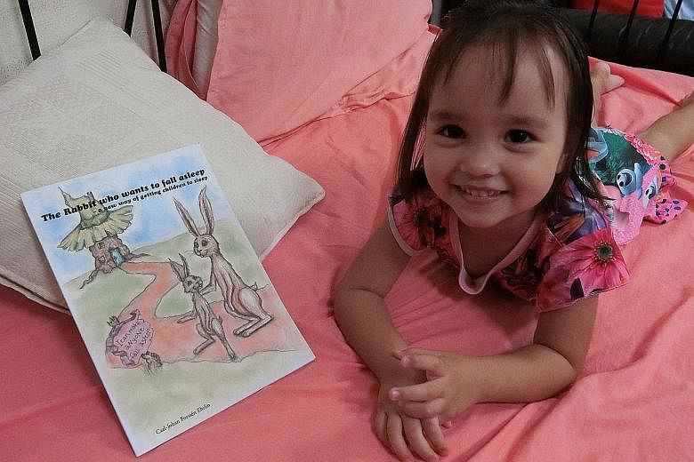 Toddler Leah (left) was not impressed by The Rabbit Who Wants To Fall Asleep, a book that claims to send children to sleep.