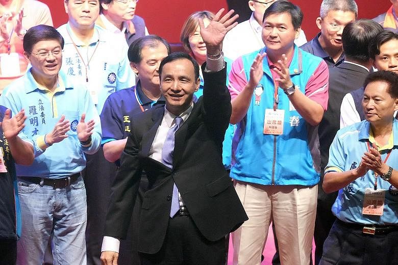Mr Eric Chu (centre), chairman of Taiwan's ruling Kuomintang, waving after being nominated as the party's presidential candidate yesterday, replacing Ms Hung Hsiu-chu, who was unceremoniously ousted after she failed to win over the public ahead of th