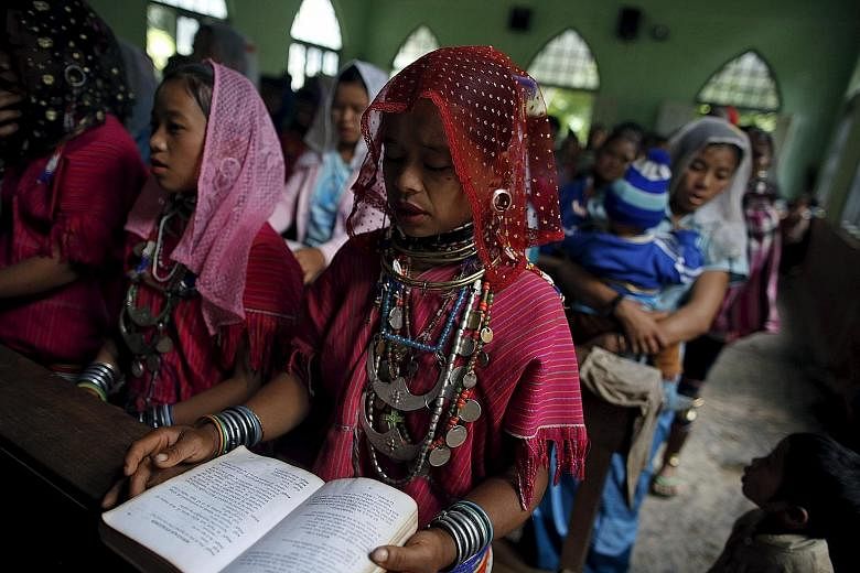 Members of the ethnic Kayaw group attending mass at the Catholic church at Htaykho village in the Kayah state. Some ethnic minorities believe that they are being persecuted for their religious beliefs.
