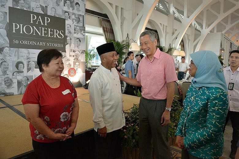 Prime Minister Lee Hsien Loong and PAP.SG chairman Halimah Yacob (right) with pioneer activists Helen Goh and Mohd Seain Madsom during the book launch at the Fullerton Bay Hotel yesterday.