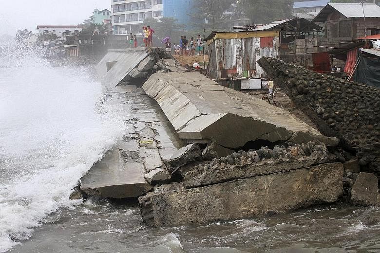 A seawall in Ilocanos Norte town, La Union province, north of Manila, lies destroyed after being hit by strong waves thrown up by Typhoon Koppu.