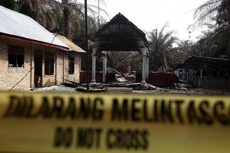 Police tape barring access to a burned church in a village in Aceh Singkil, Indonesia, last week. A mob burned down the church, leaving one person dead and forcing thousands of Christians to flee the area. Aceh is the only province in Indonesia with 