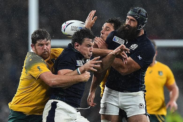 THE MAN IN THE MIDDLE (far right): Australia players celebrating their win as referee Craig Joubert dashes off the field at the end of the game. THE INCIDENT (below): The ball ricochets as (from left) Australia prop Greg Holmes, Scotland flanker John