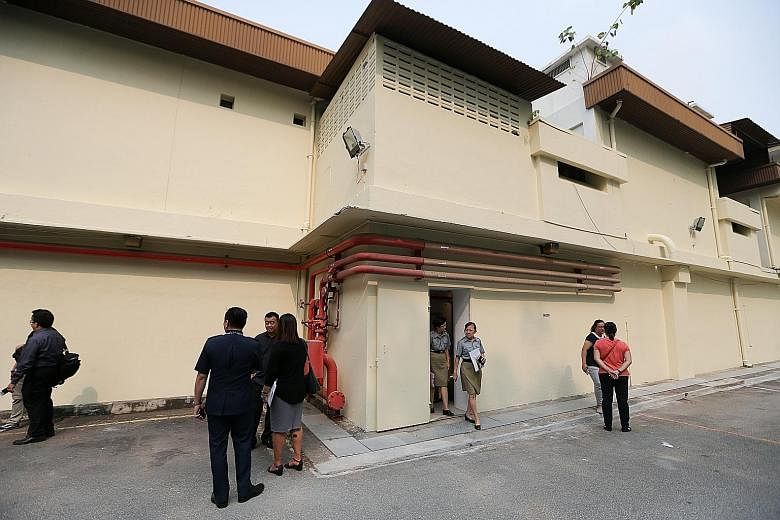 Attendees and veteran police personnel at yesterday's official opening of the Combined Operations Room bunker, which lies inside this building in Pearl's Hill Terrace.