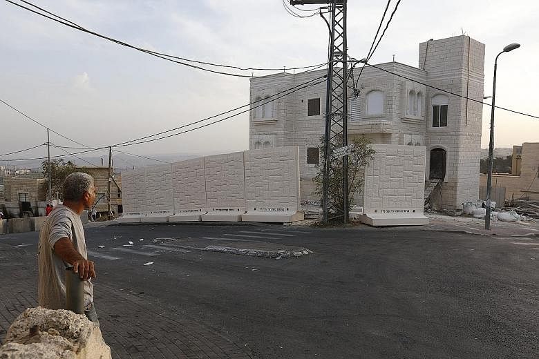 Slabs of the wall, each about 2.5m high and 2m wide, were placed by Israeli police between the Palestinian Jabel Mukaber and Jewish Armon Hanatziv neighbourhoods on Sunday.