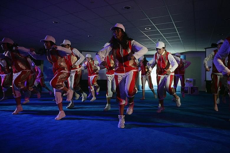 Dancers and volunteers performing an extract of the third movement of the Asean Para Games' opening ceremony during a media preview yesterday. The 90-minute multimedia show at the Singapore Indoor Stadium will include more than 1,400 participants.