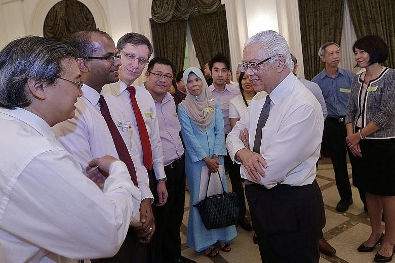 President Tony Tan Keng Yam speaking to senior lecturers from Nanyang Polytechnic - (from left) Mr Jeffrey Seng, Dr Saji George and Mr Christof Luda - during a reception at the Istana yesterday. The reception is part of the annual Public Service Mont