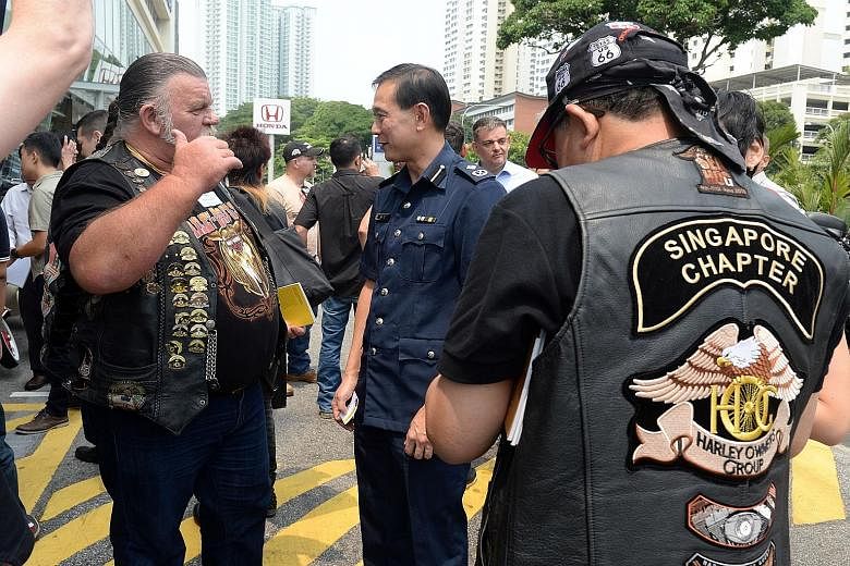 Traffic Police Commander Sam Tee speaking to motorcyclists at yesterday's dialogue at the Harley Davidson showroom in Alexandra Road. There are about 145,000 motorcycles on the roads here - about one in six vehicles - but they account for almost half