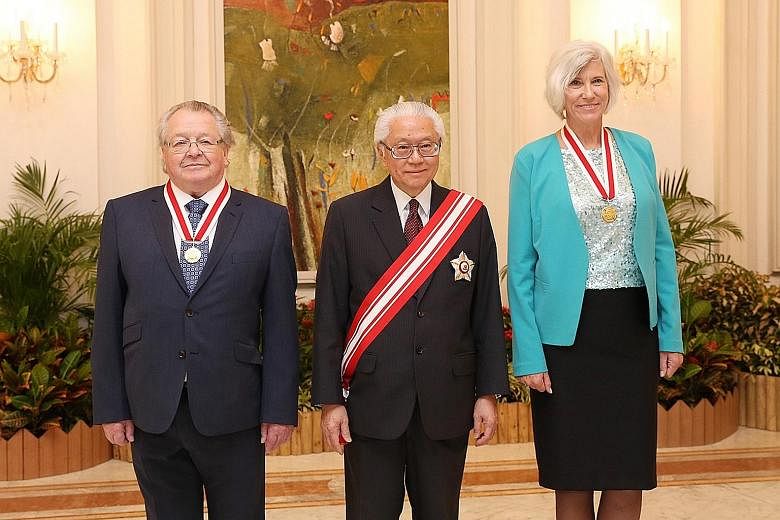 President Tony Tan Keng Yam with this year's recipients of the Honorary Citizen Award: Sir George Radda (left) and Dr Joan Rose. Prof Radda, 79, was recognised for playing a pivotal role in Singapore's biomedical sciences industry, while Dr Rose, 61,
