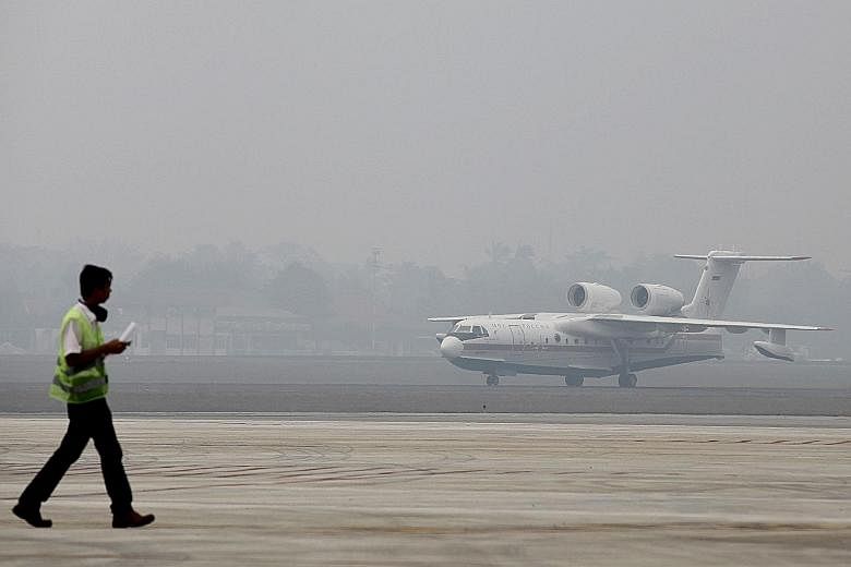 A Russian-made Beriev Be-200 amphibious firefighting aircraft arriving at an airbase in Palembang, South Sumatra province, yesterday. Indonesia has said it needs more water-bombing aircraft to fight its fires.