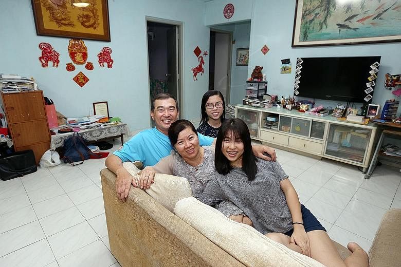 Mr Liew Cheng Liang, 54, with his wife, Jojo Oo, 52, and two of their three daughters, Chloe (foreground), 21, and Evon, 13. Thanks to the HDB's relaxed rule allowing sellers to negotiate for a temporary extension of stay, the family can stay on in t