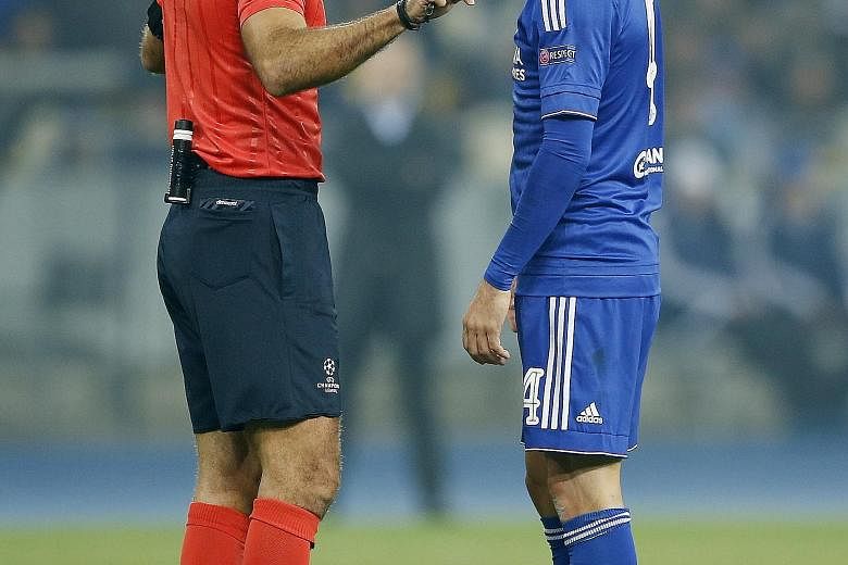 Chelsea's Cesc Fabregas speaks to referee Damir Skomina after being denied a penalty. Chelsea are in third place in Champions League Group G after their 0-0 draw.