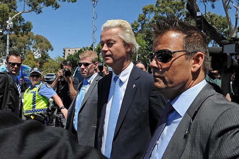 Mr Geert Wilders (centre) leaving Parliament House in Perth yesterday after a press conference.