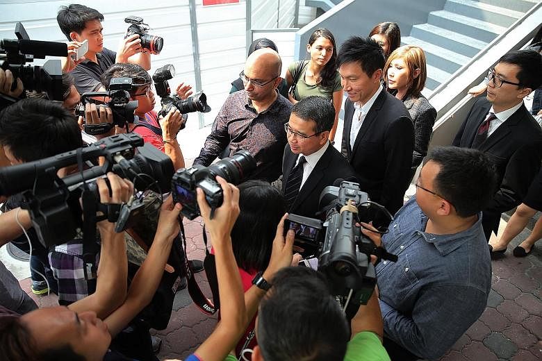 Lawyer Edwin Tong (facing the media, with tie), Kong Hee (behind Mr Tong) and Kong's wife Ho Yeow Sun (behind Kong) leaving the courts on Wednesday. Kong and five others were on Wednesday convicted of misusing some $50 million in City Harvest Church 