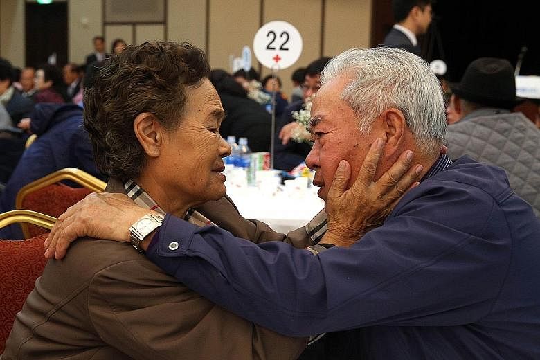 Mr Lee Cheon Woo, from South Korea, and his sister Ri Mun Woo, from North Korea, bidding farewell yesterday after an emotional three-day family reunion at the Mount Kumgang resort on the North's south-eastern coast. The mass event, which involved som