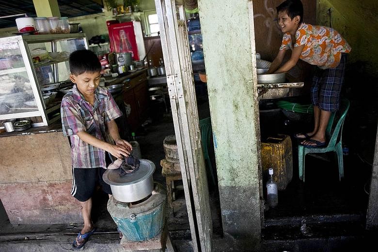 Children working in a tea shop on the outskirts of Yangon. In Myanmar, child workers often toil 14 hours a day, seven days a week. The country is the world's seventh worst for child labour, just ahead of India and Liberia.