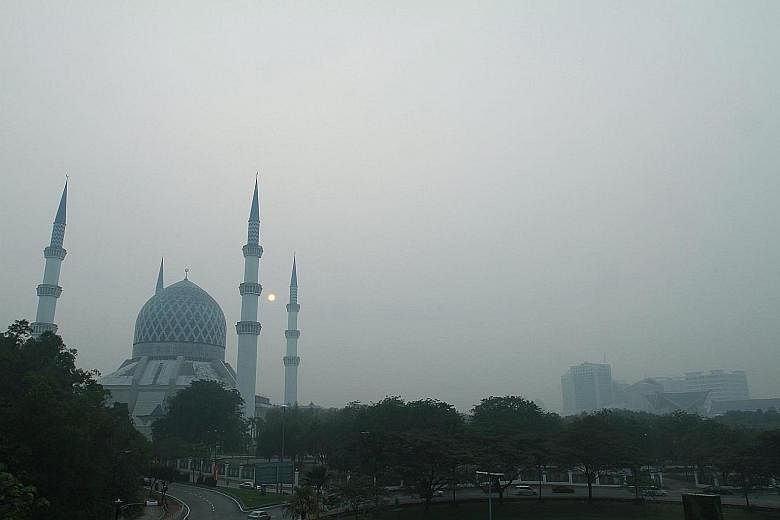 Hazy skies in Shah Alam, Selangor, yesterday. Elsewhere in Malaysia, schools in the northern states of Penang, Perlis and Perak were ordered to suspend classes today owing to the haze.