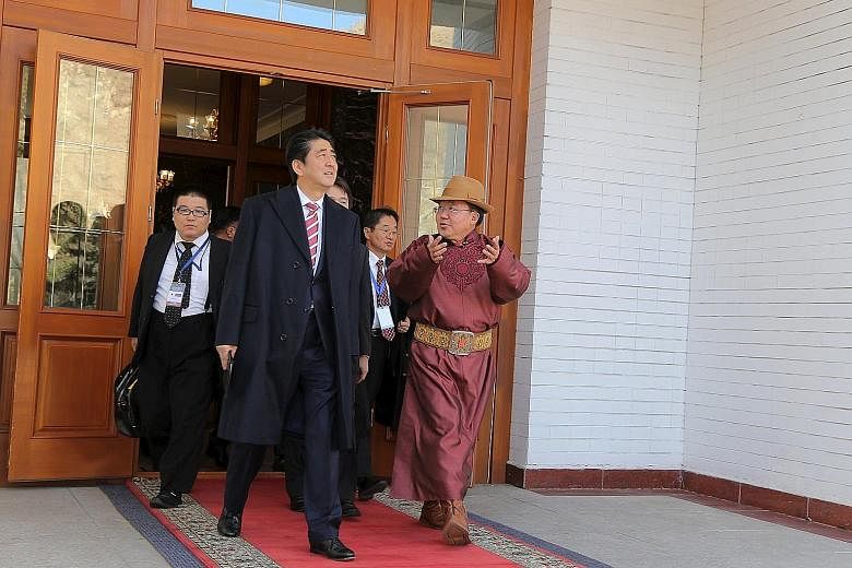 Mr Abe with Mongolian President Tsakhiagiin Elbegdorj during their meeting at the presidential palace in Ulan Bator yesterday.