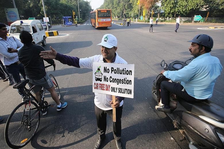 A volunteer taking part in a cycle rally to mark the first Car Free Day in New Delhi on Thursday.