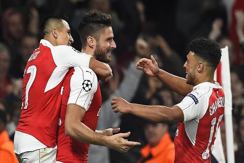 Olivier Giroud (centre) with Alexis Sanchez (left) and Alex Oxlade-Chamberlain after scoring the first goal against Bayern Munich on Wednesday. Giroud and Theo Walcott are both in stellar form for Arsene Wenger's team.